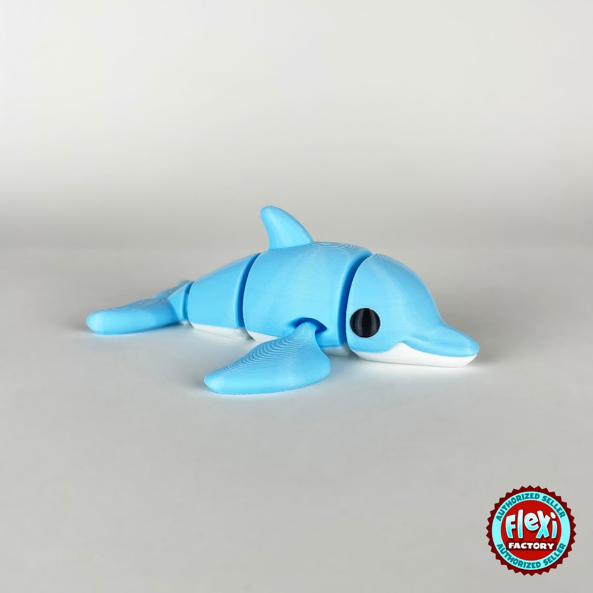 Cute dolphin keychain, 3D printed by RU3D – profile view facing right. Sky blue with white belly.