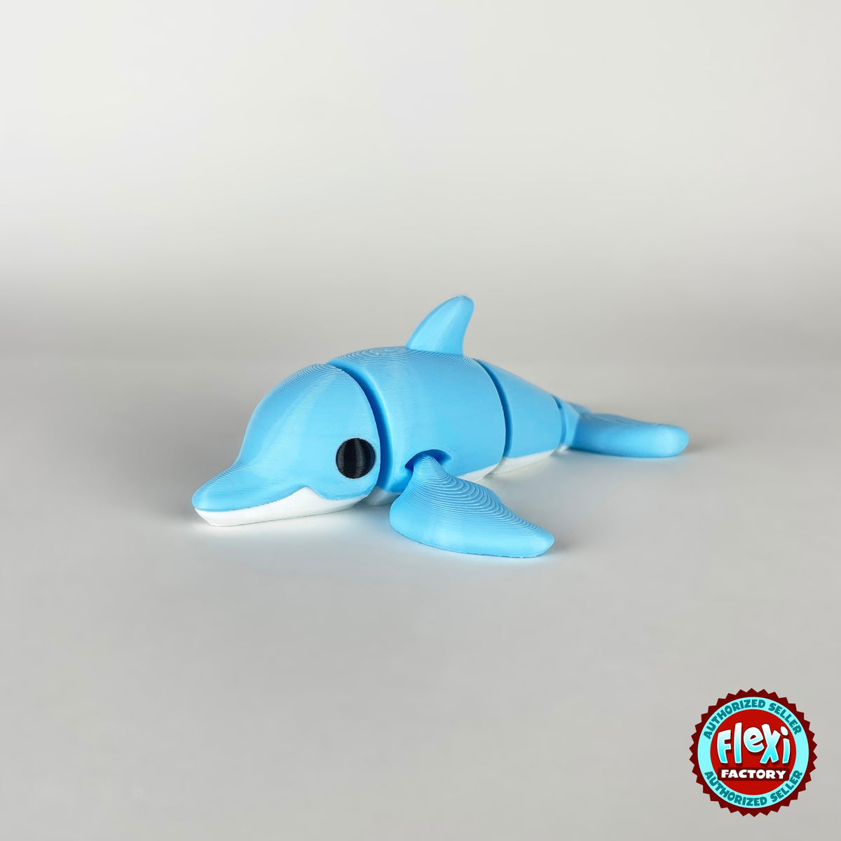 Cute dolphin keychain, 3D printed by RU3D – side view facing left. Sky blue with white belly.
