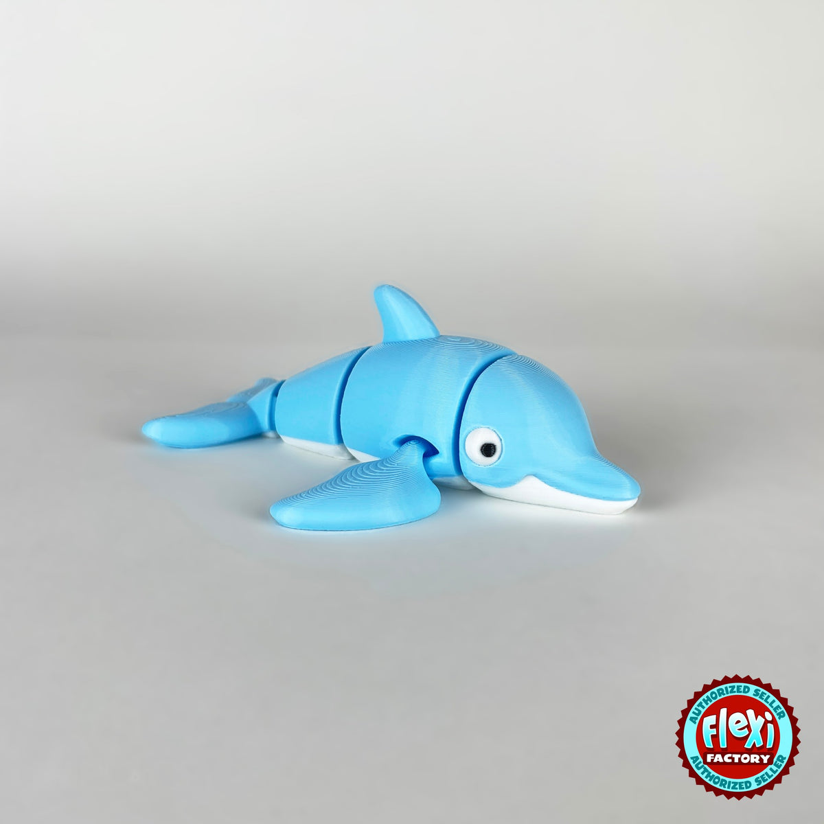 Cute dolphin keychain, 3D printed by RU3D – side view facing right. Sky blue with white belly.