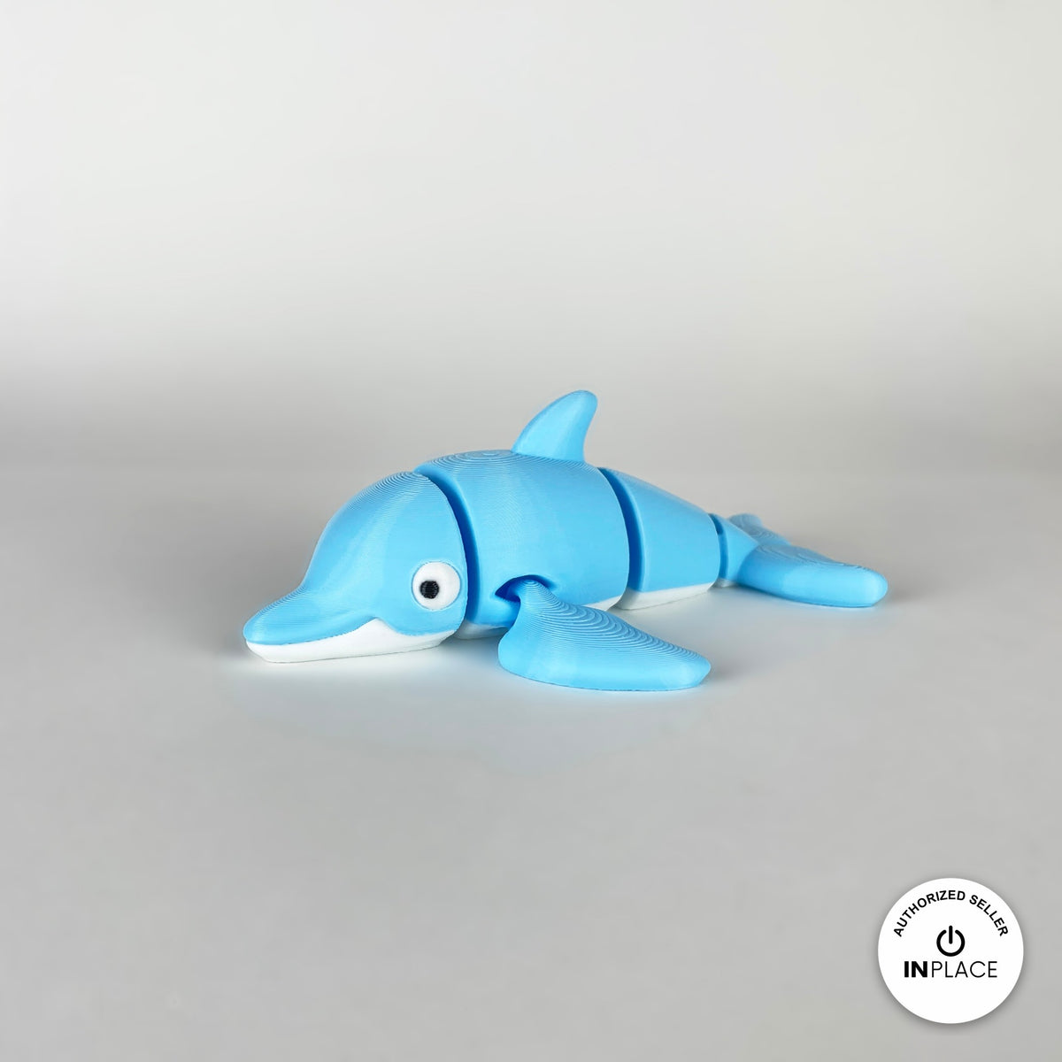 Cute dolphin keychain, 3D printed by RU3D – three quarter view facing left. Sky blue with white belly.
