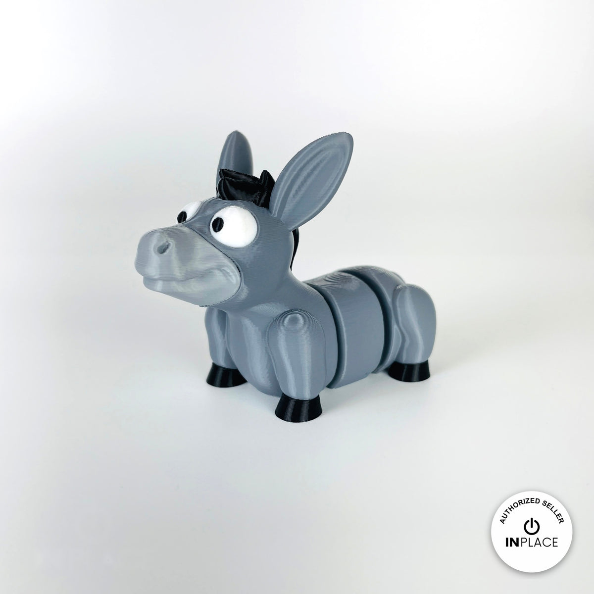 Cute donkey keychain, 3D printed by RU3D – three quarter view facing left. Grey with black mane and hooves.