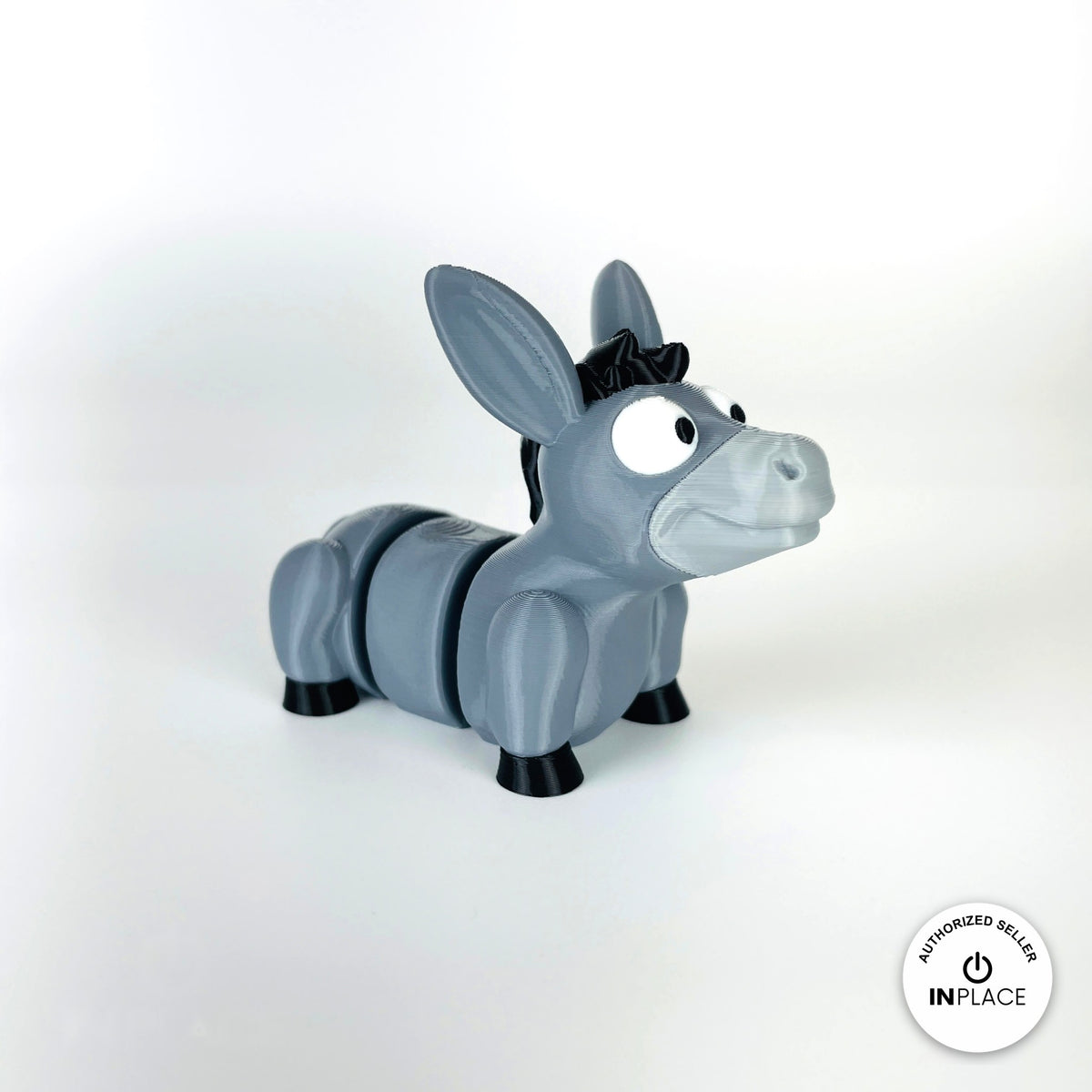 Cute donkey keychain, 3D printed by RU3D – three quarter view facing right. Grey with black mane and hooves.