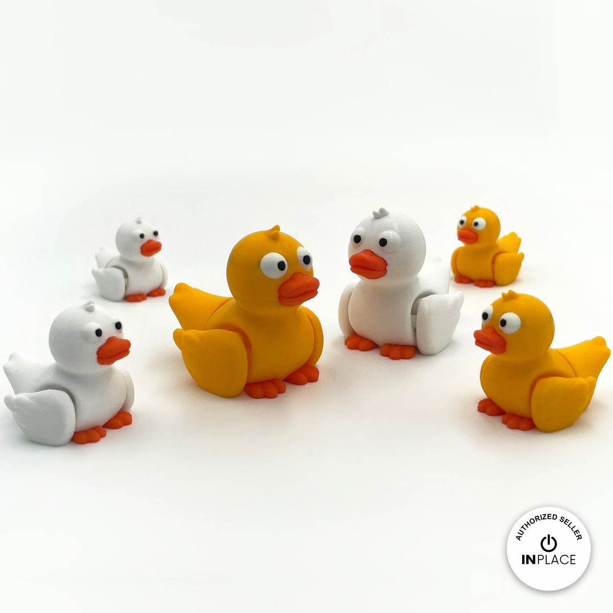 Cute duck keychain, 3D printed by RU3D – group of yellow and white ducks. Yellow with orange beak, also in white.