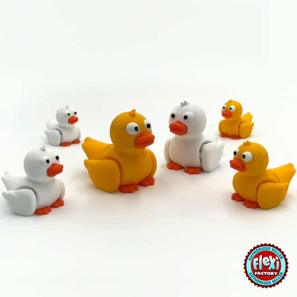 Cute duck keychain, 3D printed by RU3D – group of yellow and white ducks. Yellow with orange beak, also in white.