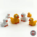 Cute duck keychain, 3D printed by RU3D – group of yellow and white ducks. Yellow with orange beak, also in white.