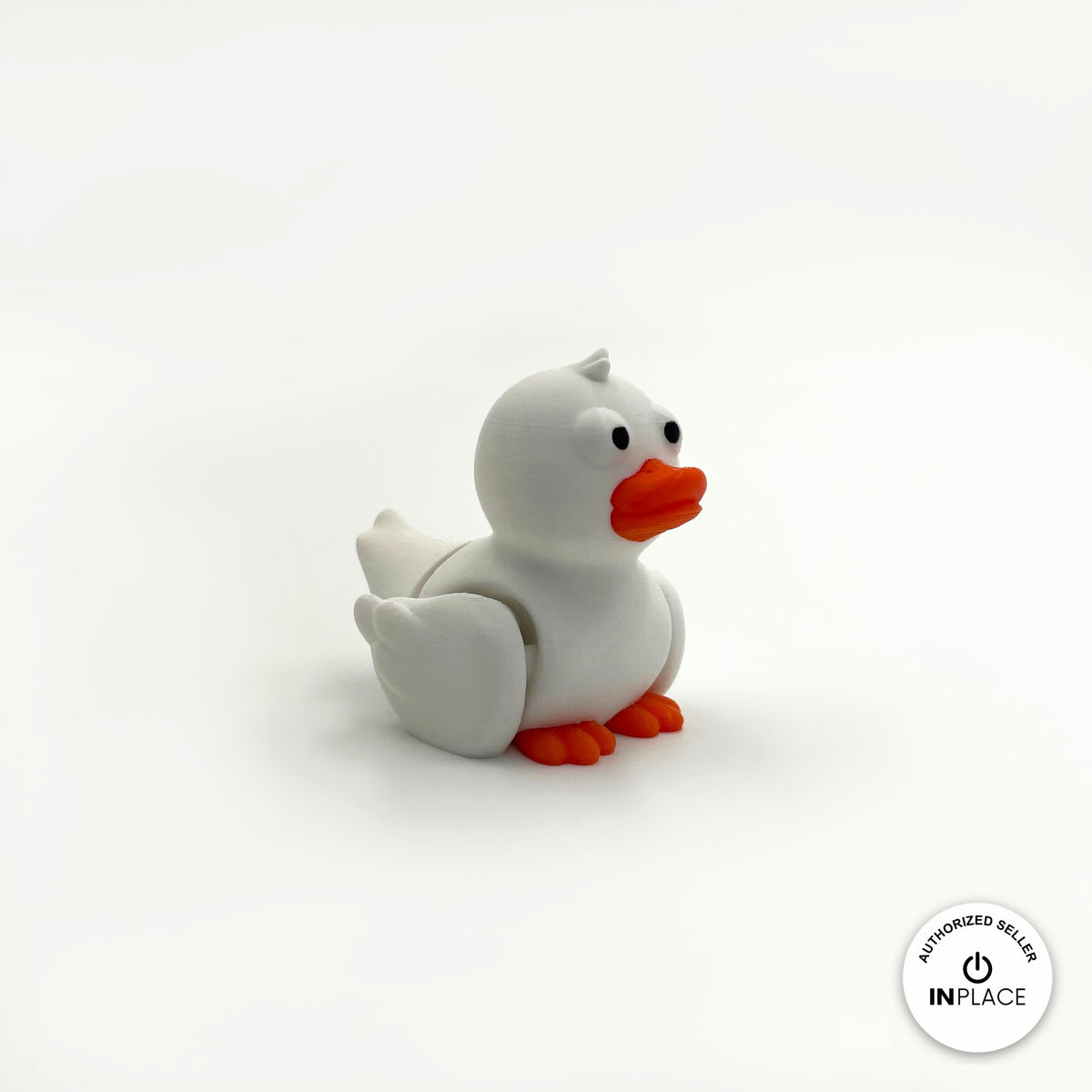 Cute duck keychain, 3D printed by RU3D – white duck three quarter view facing right. Yellow with orange beak, also in white.