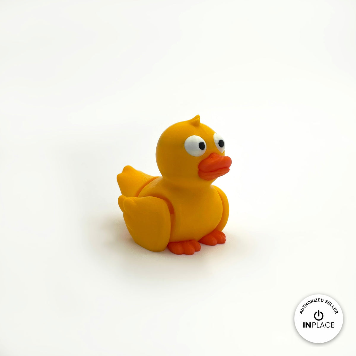 Cute duck keychain, 3D printed by RU3D – yellow duck three quarter view facing right. Yellow with orange beak, also in white.