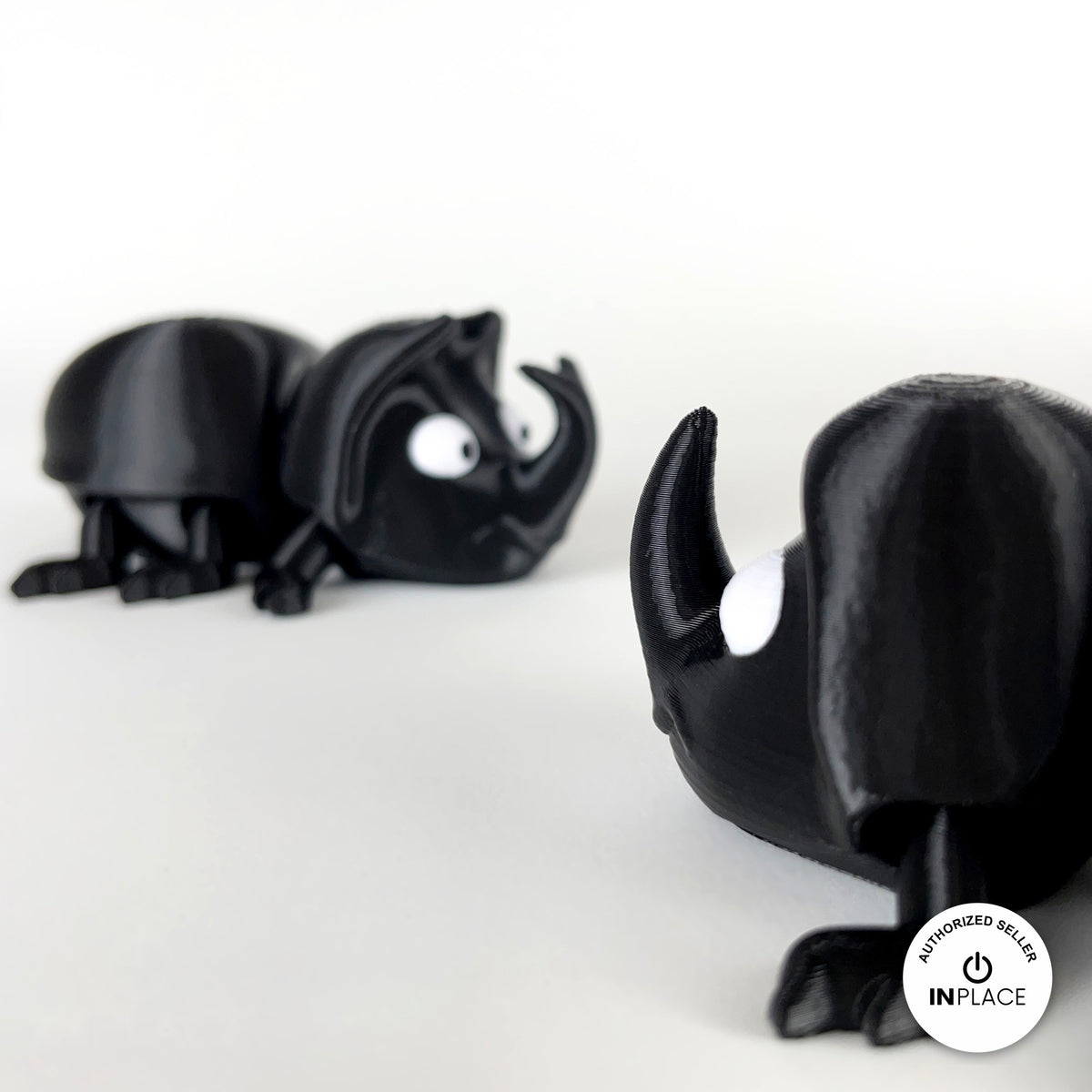 Cute dung beetle keychain, 3D printed by RU3D – close up horn with beetle behind. Black rhino beetle with brown dung ball.