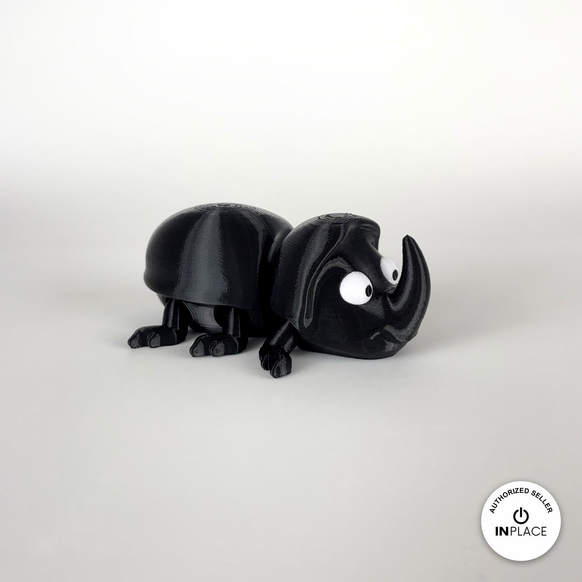 Cute dung beetle keychain, 3D printed by RU3D – side view facing right. Black rhino beetle with brown dung ball.