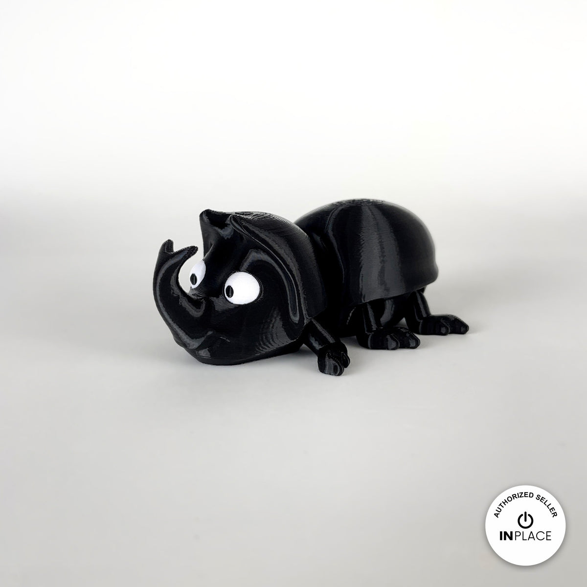 Cute dung beetle keychain, 3D printed by RU3D – three quarter view facing left. Black rhino beetle with brown dung ball.