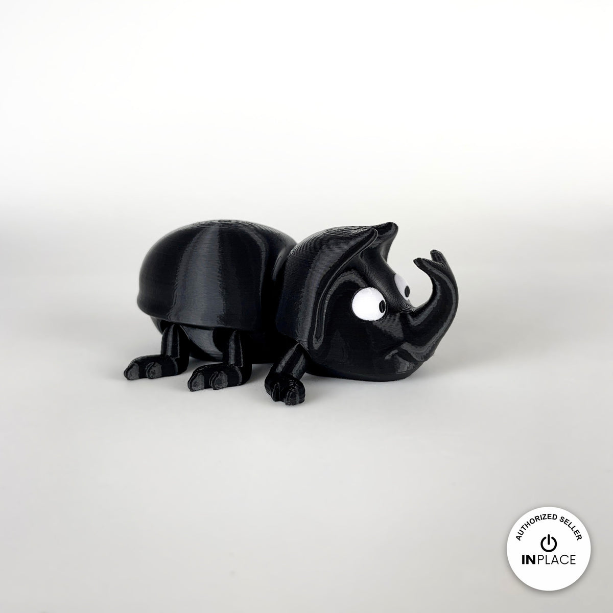 Cute dung beetle keychain, 3D printed by RU3D – three quarter view facing right. Black rhino beetle with brown dung ball.