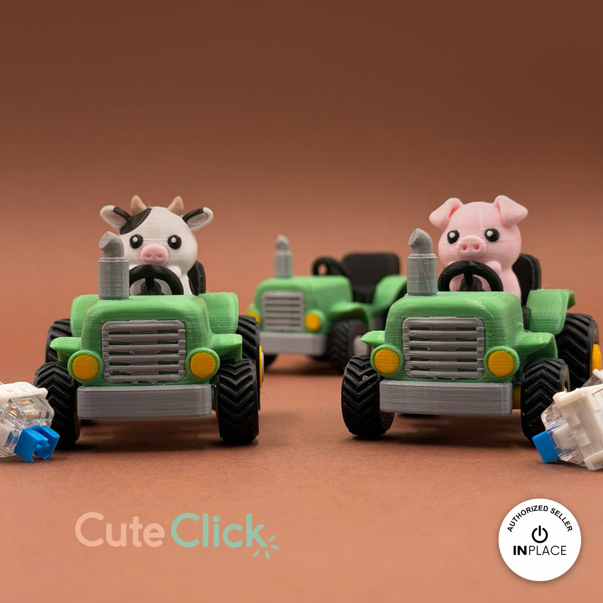 Cute farm tractor keychain, 3D printed by RU3D – cow and pig driving tractors. Green and grey with cow and pig drivers.