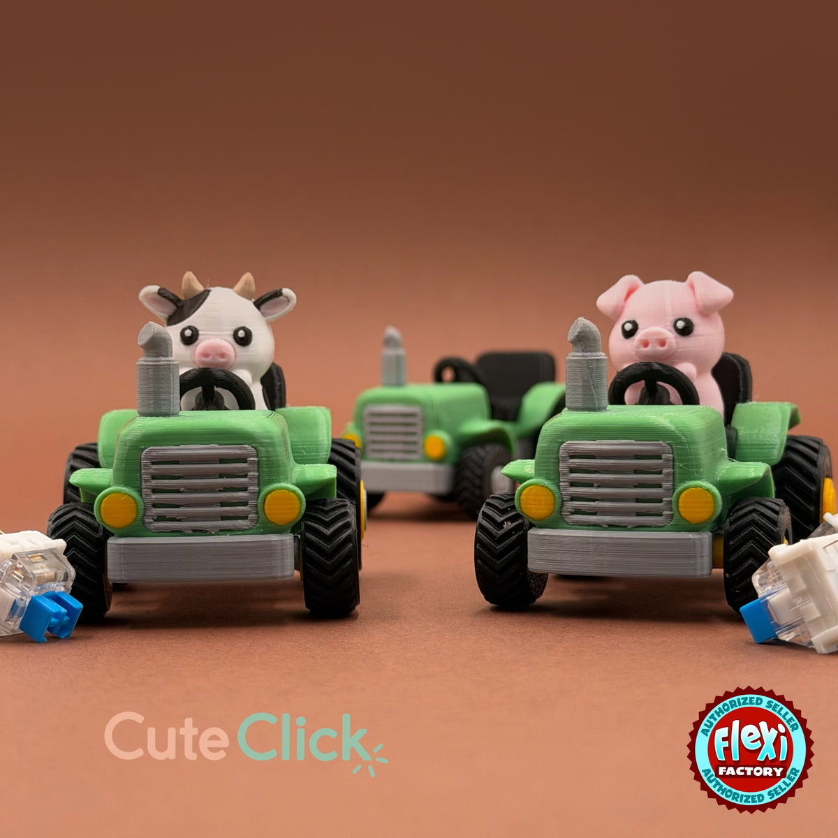 Cute farm tractor keychain, 3D printed by RU3D – cow and pig driving tractors. Green and grey with cow and pig drivers.