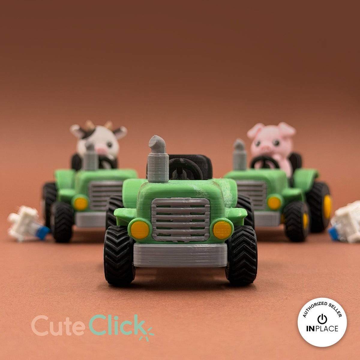 Cute farm tractor keychain, 3D printed by RU3D – front view with cow and pig tractors. Green and grey with cow and pig drivers.