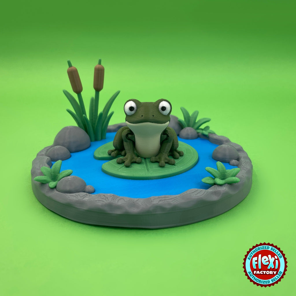 Cute frog keychain, 3D printed by RU3D – on lily pad with pond playset. Olive green with lily pond playset.