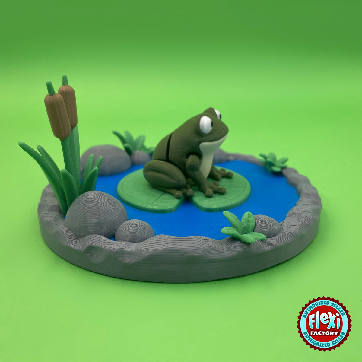 Cute frog keychain, 3D printed by RU3D – side view on pond playset. Olive green with lily pond playset.