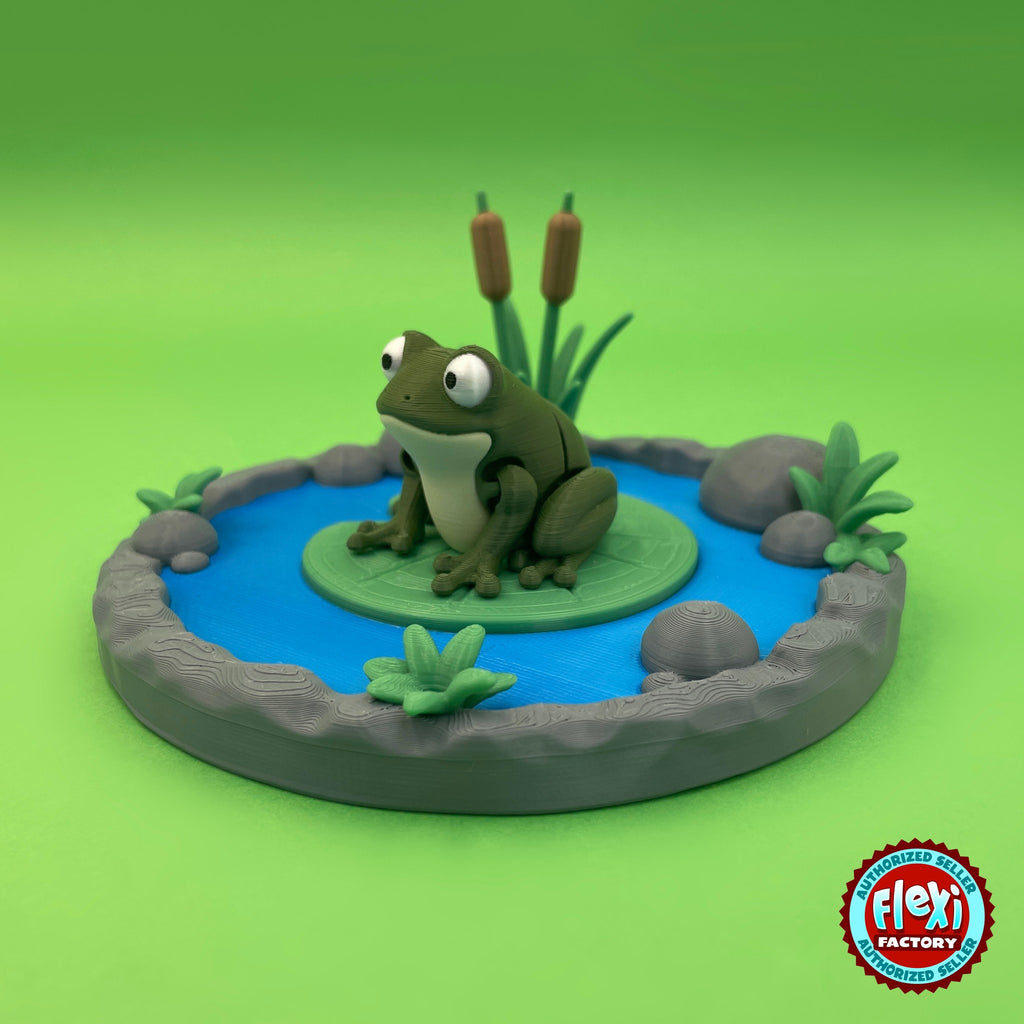 Cute frog keychain, 3D printed by RU3D – three quarter view on lily pad. Olive green with lily pond playset.