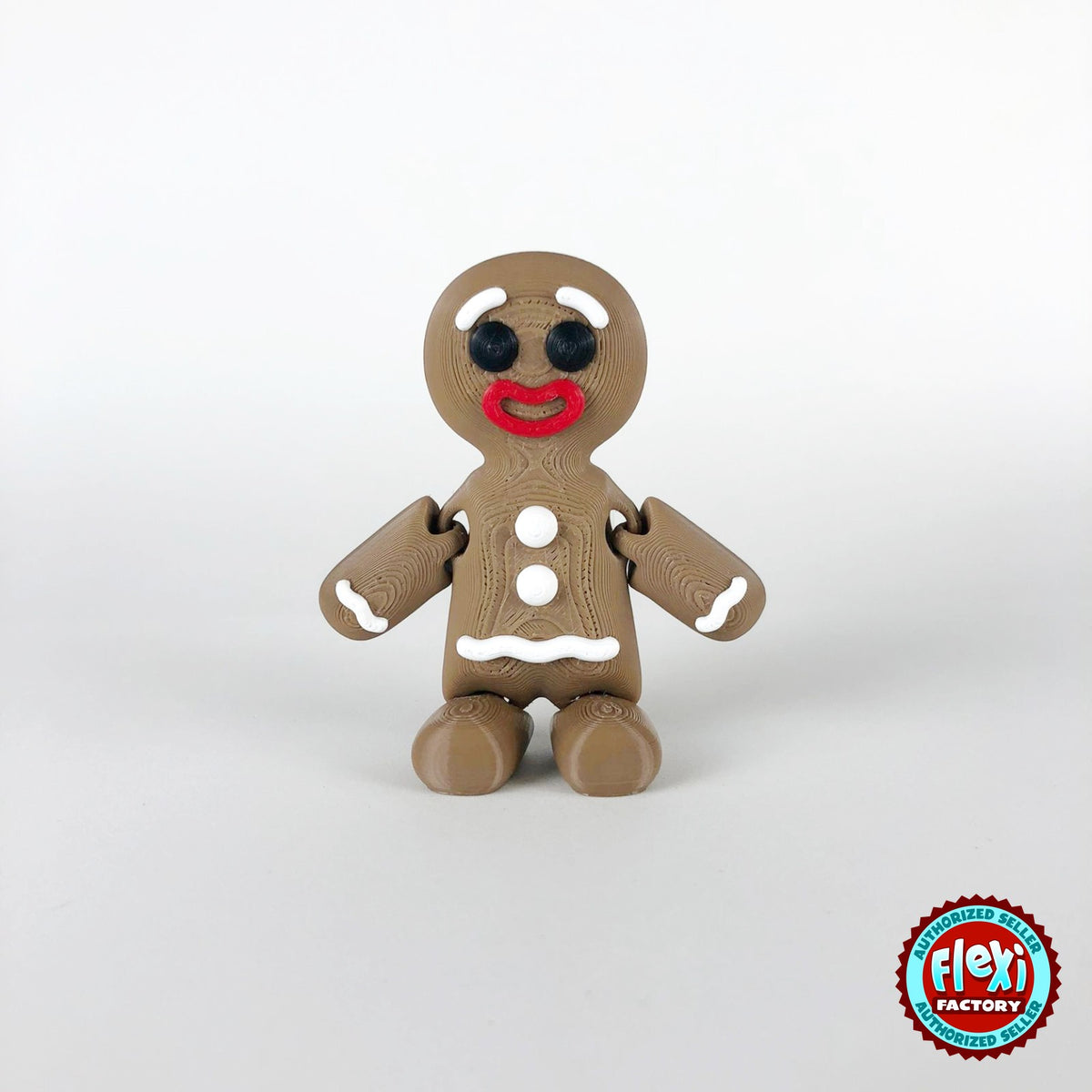 Cute gingerbread man keychain, 3D printed by RU3D – dark eyes front view. Brown with white icing and red Santa hat.