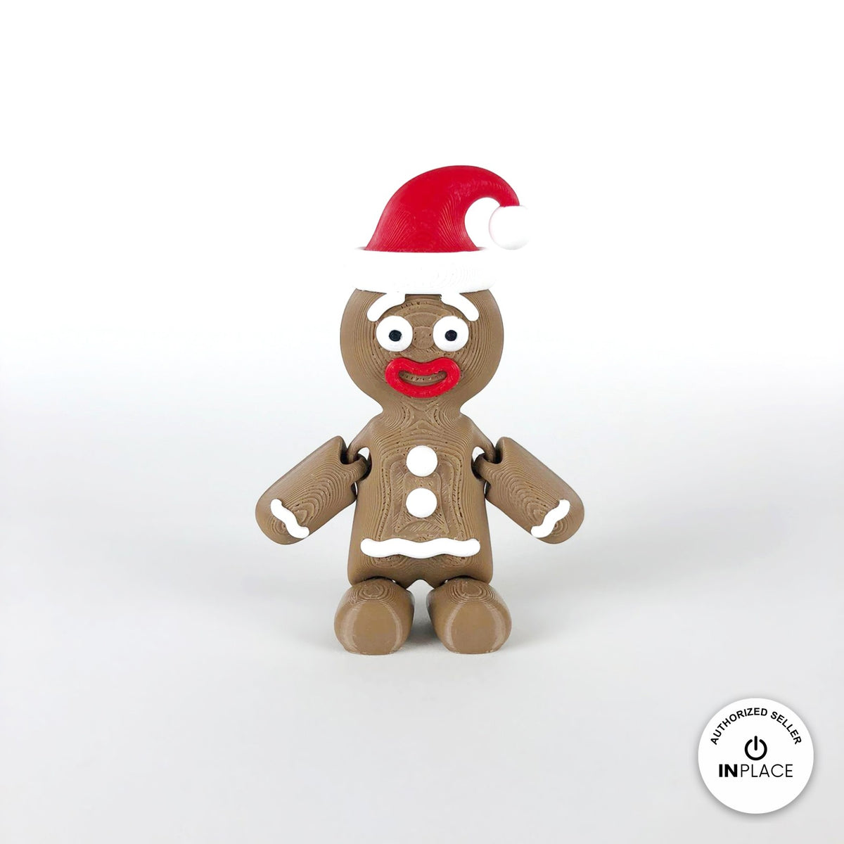 Cute gingerbread man keychain, 3D printed by RU3D – with Santa hat front view. Brown with white icing and red Santa hat.