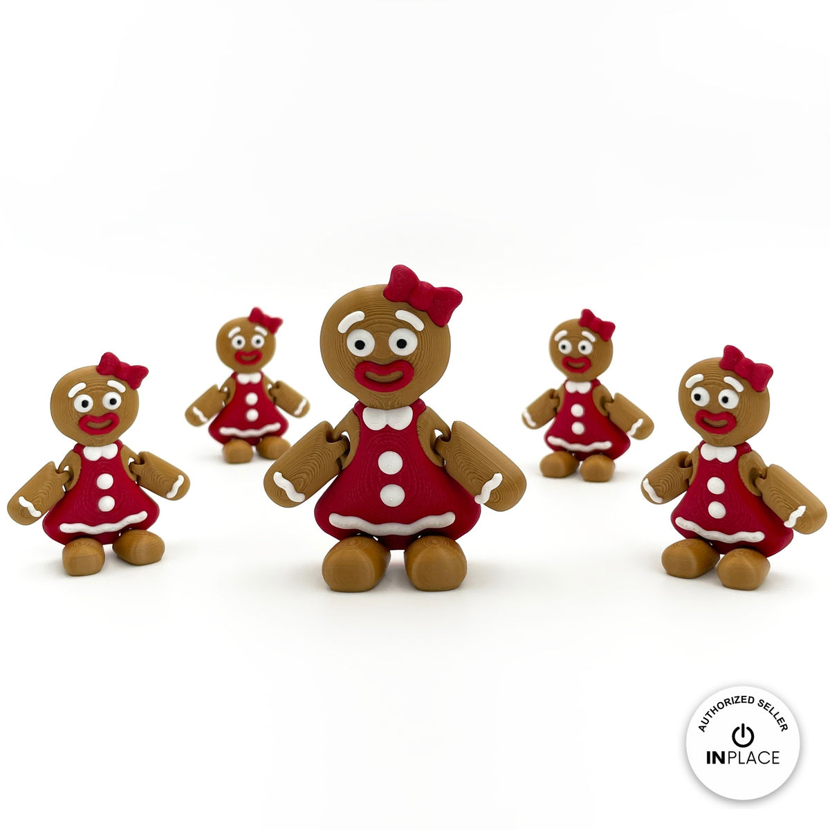 Cute gingerbread woman keychain, 3D printed by RU3D – group of gingerbread women. Brown with red dress and bow.