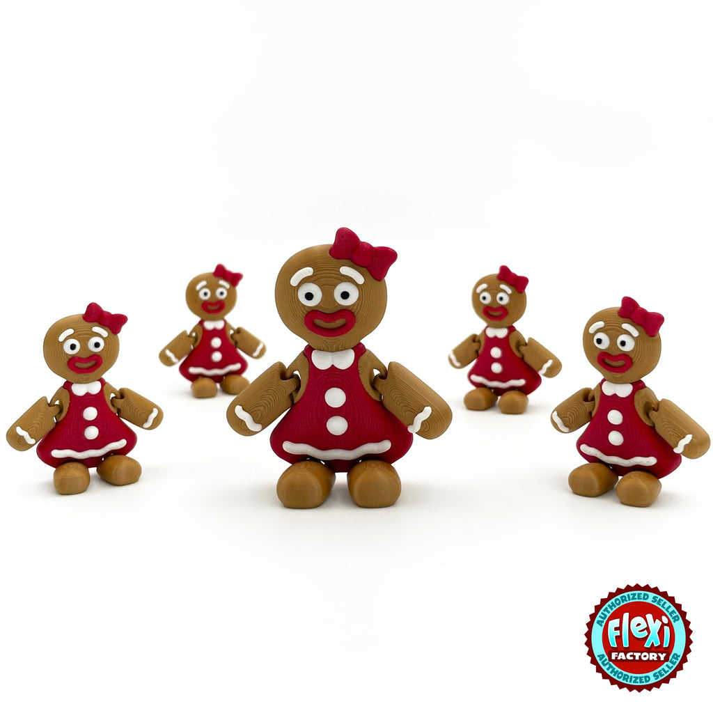 Cute gingerbread woman keychain, 3D printed by RU3D – group of gingerbread women. Brown with red dress and bow.