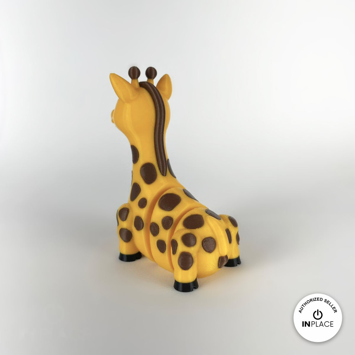 Cute giraffe keychain, 3D printed by RU3D – rear three quarter view. Yellow with brown spots.
