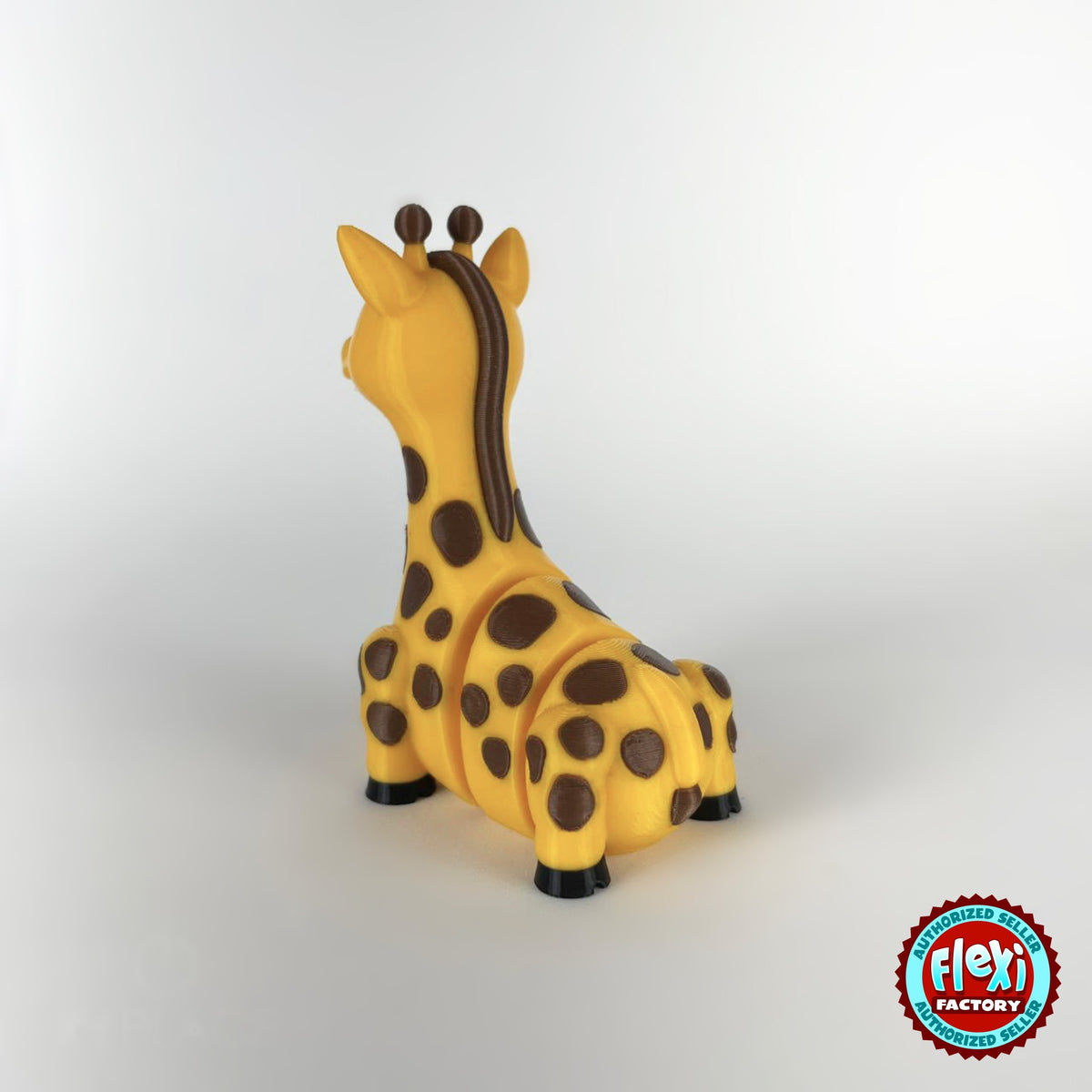Cute giraffe keychain, 3D printed by RU3D – rear three quarter view. Yellow with brown spots.