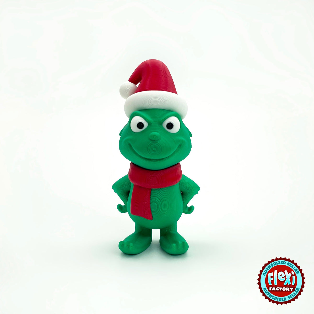 Cute green Christmas grump keychain, 3D printed by RU3D – with Santa hat front view. Green with red scarf and Santa hat.