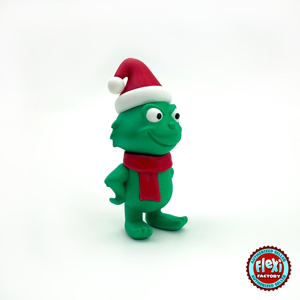 Cute green Christmas grump keychain, 3D printed by RU3D – with Santa hat side view facing right. Green with red scarf and Santa hat.