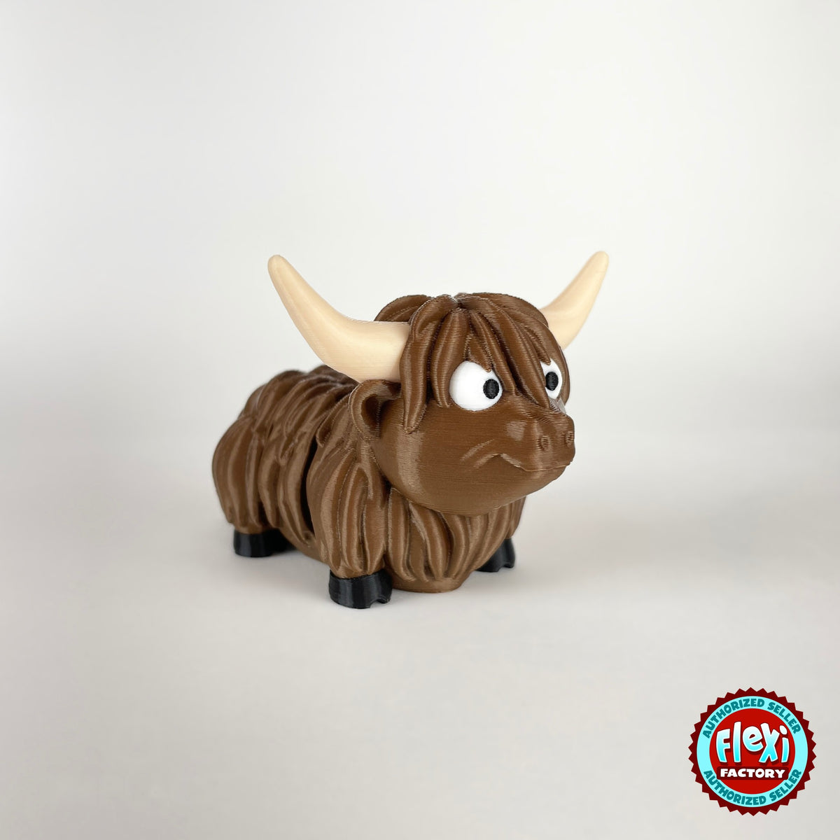 Cute Highland cow keychain, 3D printed by RU3D – three quarter view facing right looking up. Shaggy brown with cream horns.