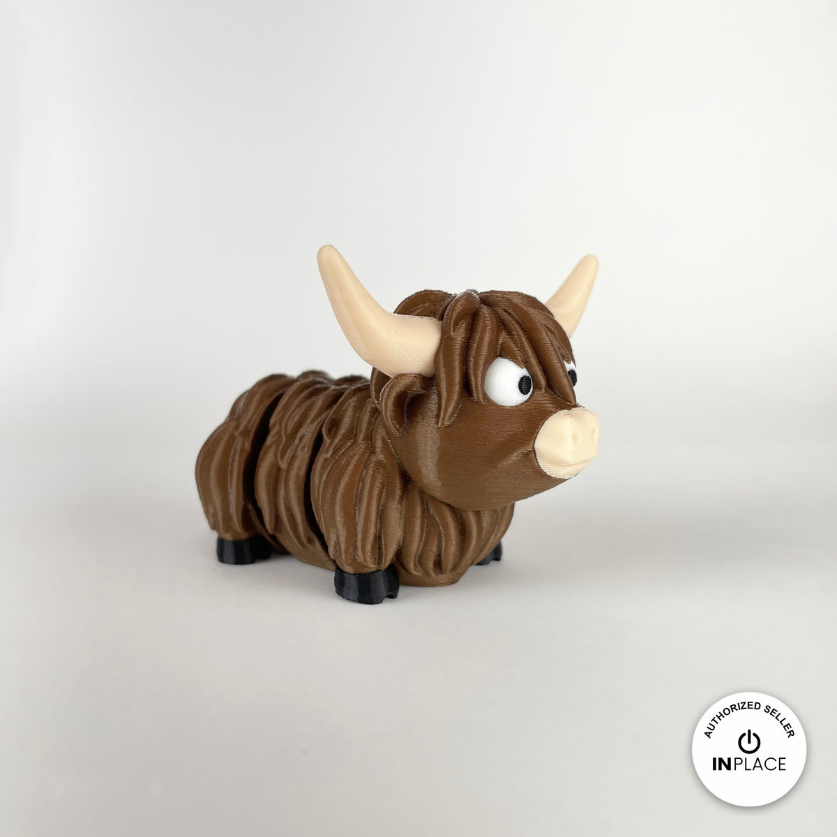 Cute Highland cow keychain, 3D printed by RU3D – three quarter view facing right. Shaggy brown with cream horns.