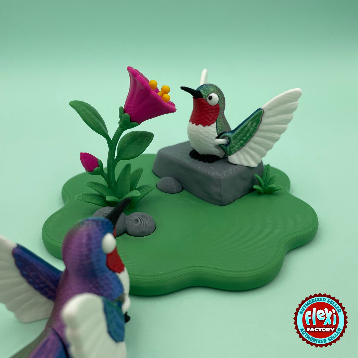 Cute hummingbird keychain, 3D printed by RU3D – close up with flower playset. Green and red bird with flower garden playset.