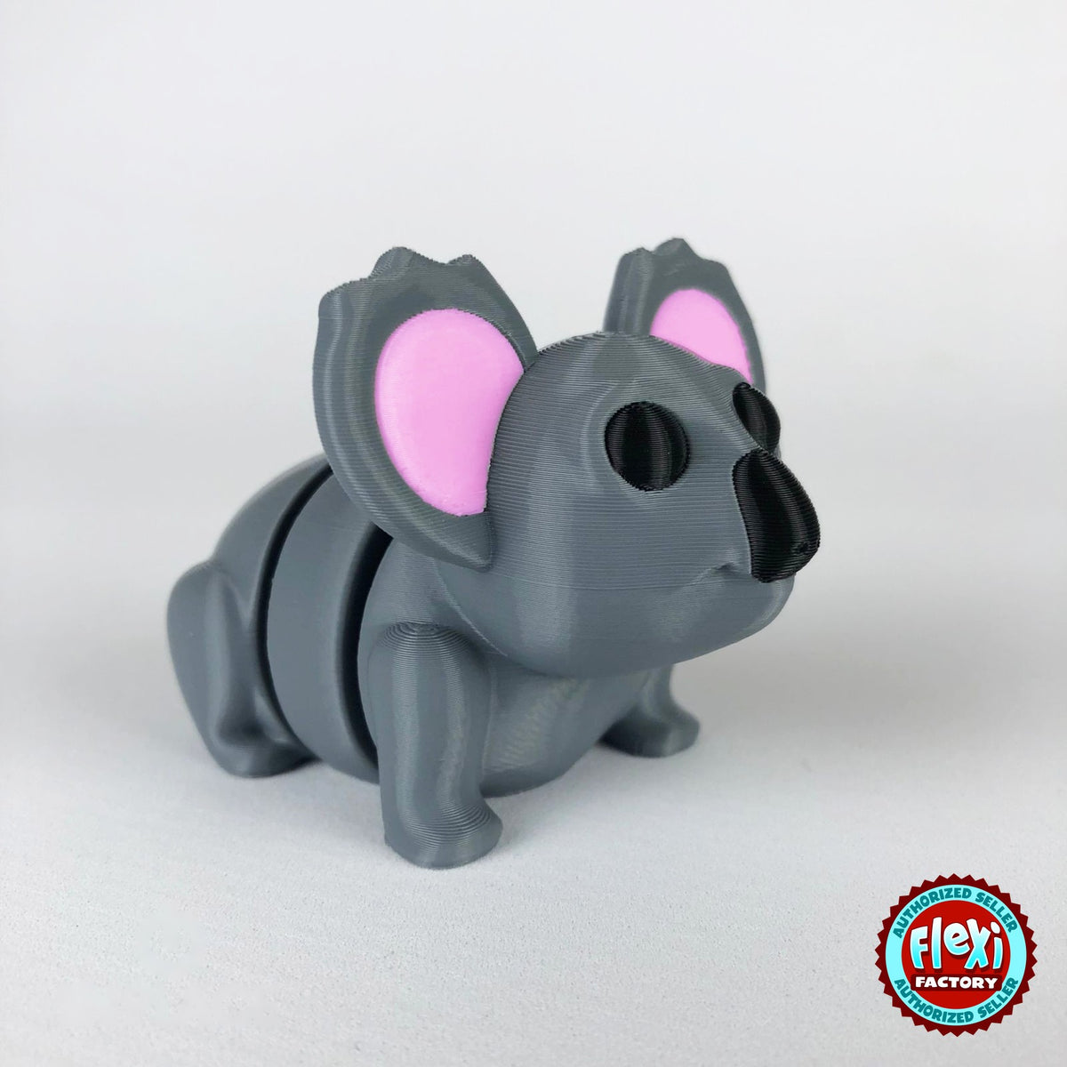 Cute koala keychain, 3D printed by RU3D – dark eyes three quarter view facing right. Grey with pink ears.