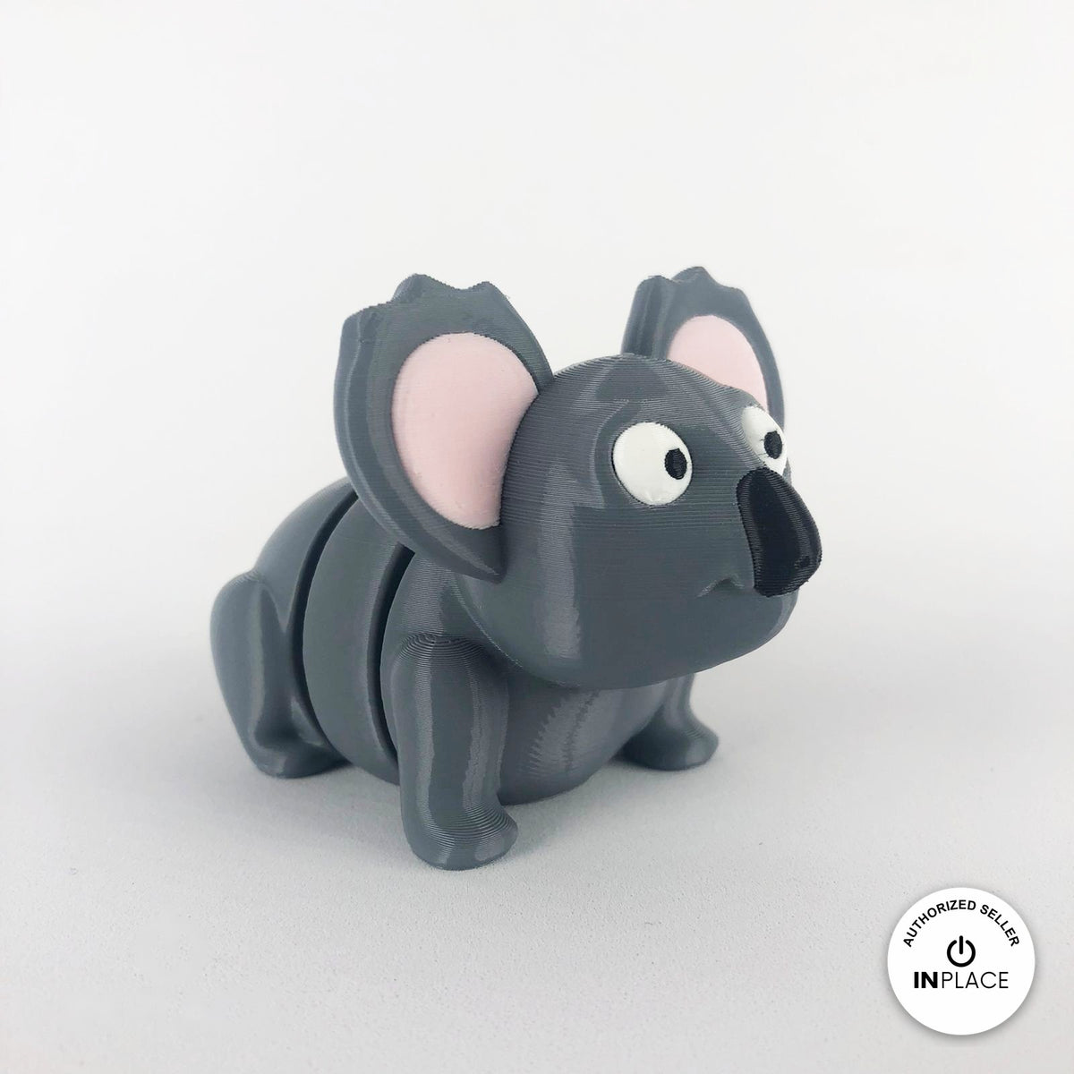 Cute koala keychain, 3D printed by RU3D – three quarter view facing right. Grey with pink ears.