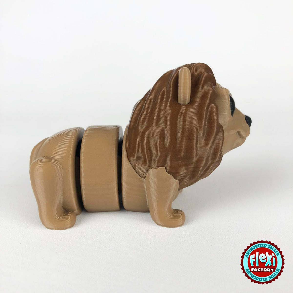 Cute lion keychain, 3D printed by RU3D – dark eyes side view facing right. Tan with brown mane.