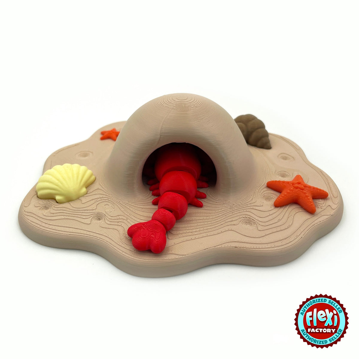 Cute lobster keychain, 3D printed by RU3D – tail in beach cave playset. Bright red with sandy beach cave playset.