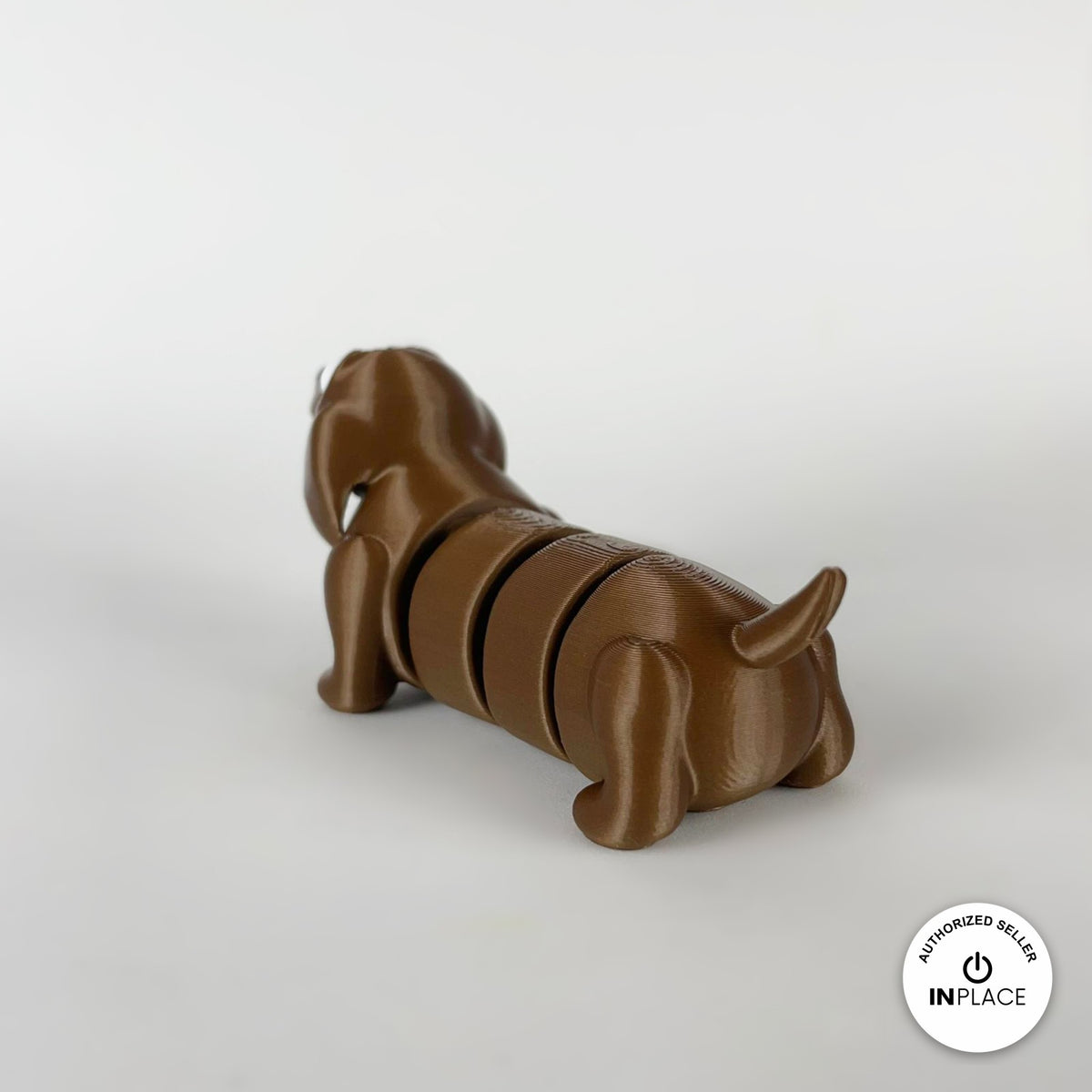 Cute long dachshund sausage dog keychain, 3D printed by RU3D – rear three quarter view. Brown, extra-long body.