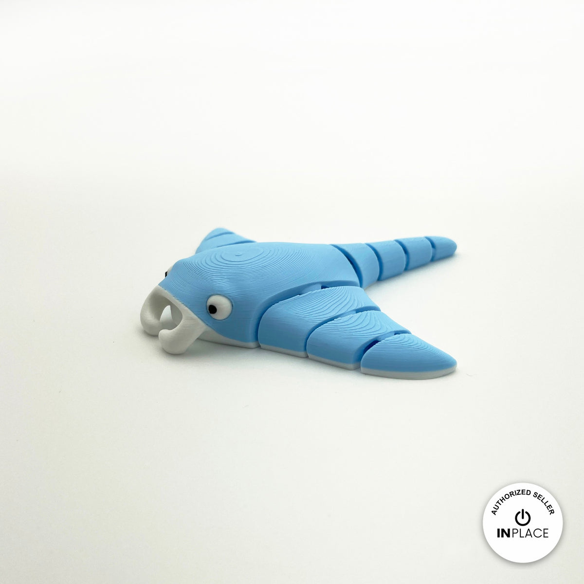 Cute manta ray keychain, 3D printed by RU3D – blue three quarter view facing left. Light blue, also in grey.
