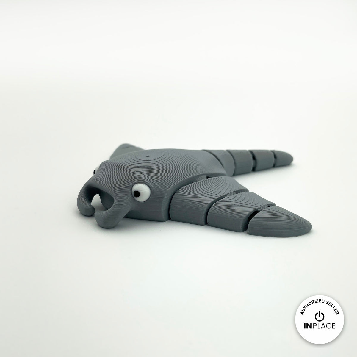 Cute manta ray keychain, 3D printed by RU3D – grey three quarter view facing left. Light blue, also in grey.