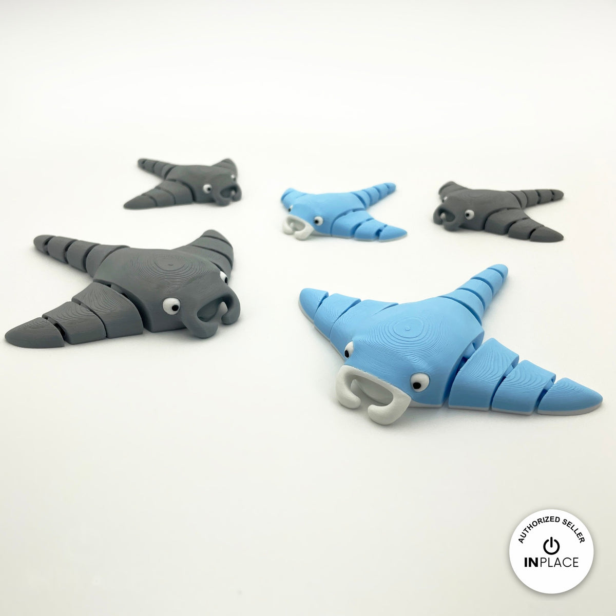 Cute manta ray keychain, 3D printed by RU3D – group of blue and grey manta rays. Light blue, also in grey.