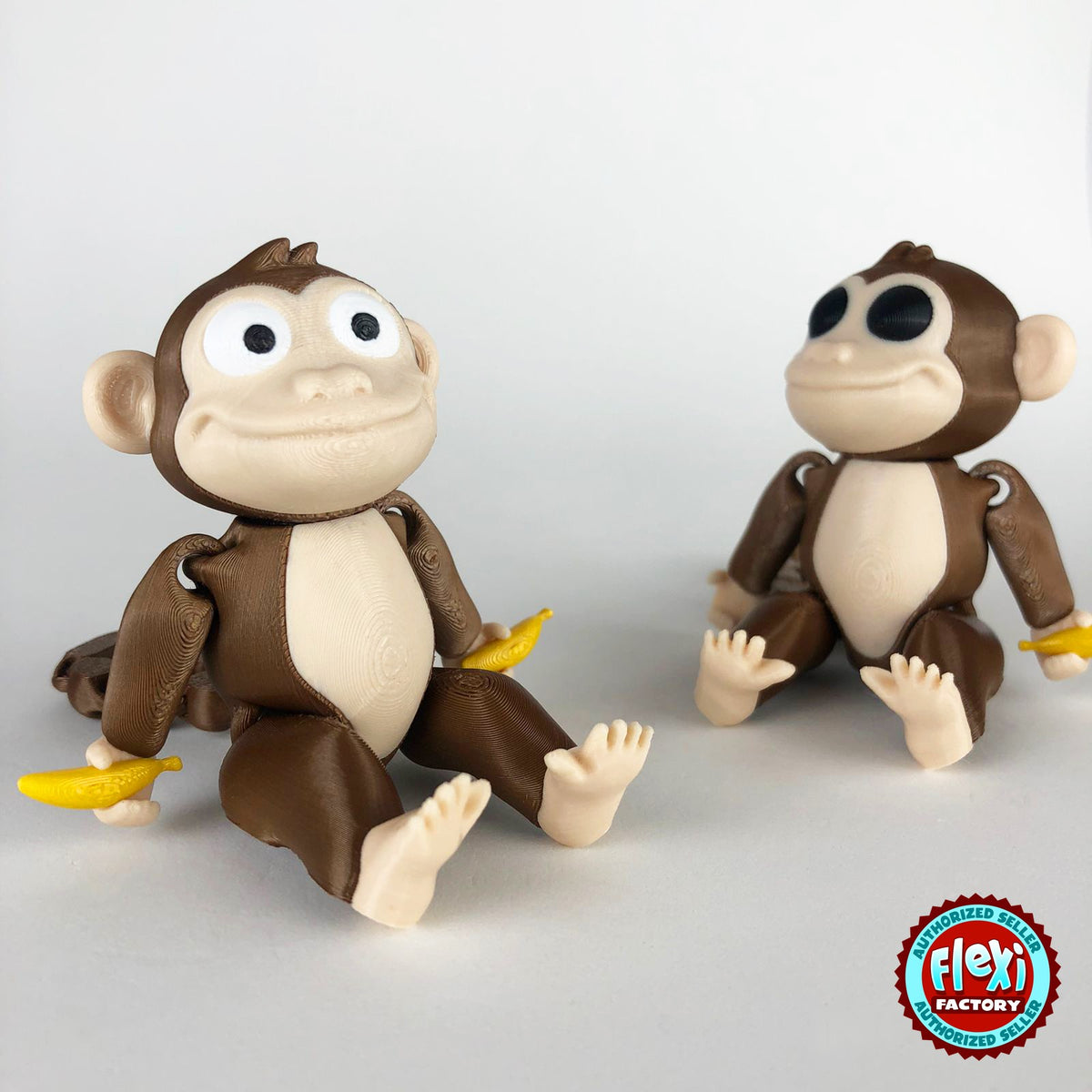 Cute monkey keychain, 3D printed by RU3D – pair of monkeys with bananas. Brown with cream face and yellow banana.