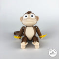 3D printed banana accessory by RU3D, shown with the Monkey keychain