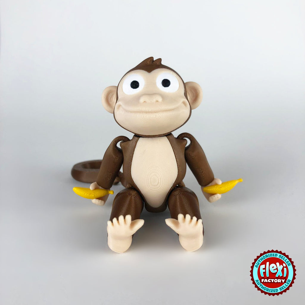 Cute monkey keychain, 3D printed by RU3D – sitting front view with banana. Brown with cream face and yellow banana.