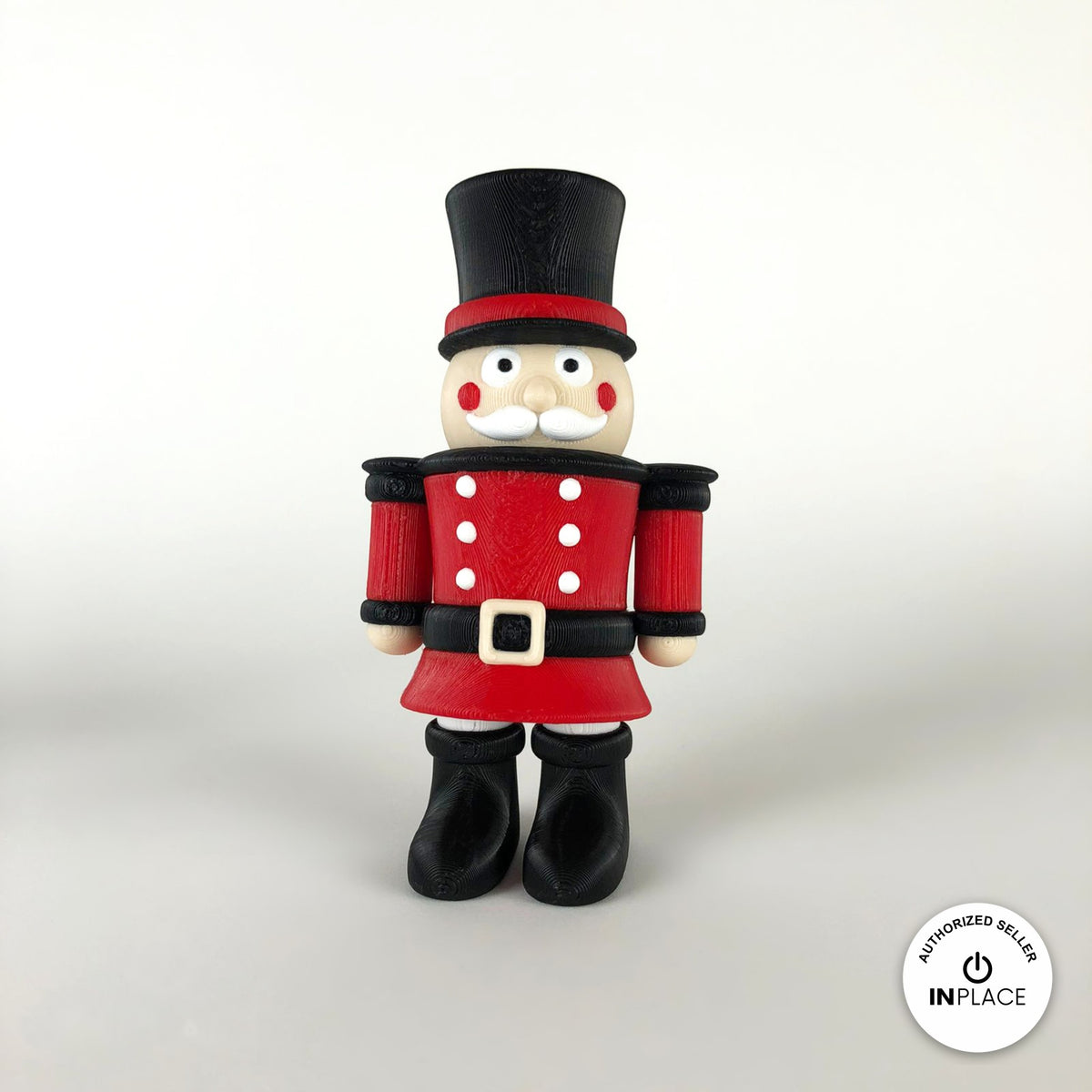 Cute nutcracker soldier keychain, 3D printed by RU3D – front view. Red jacket with black top hat and boots.