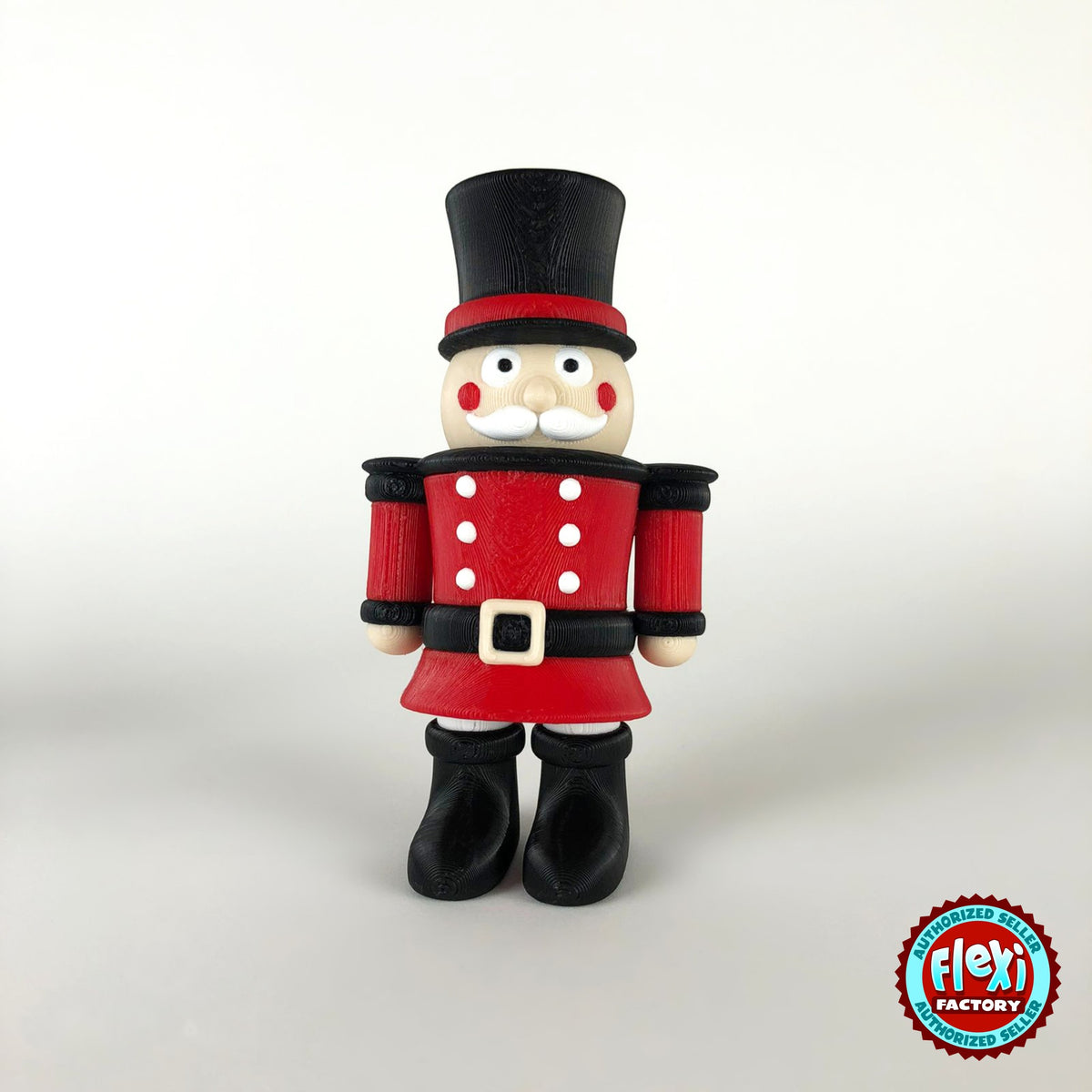 Cute nutcracker soldier keychain, 3D printed by RU3D – front view. Red jacket with black top hat and boots.