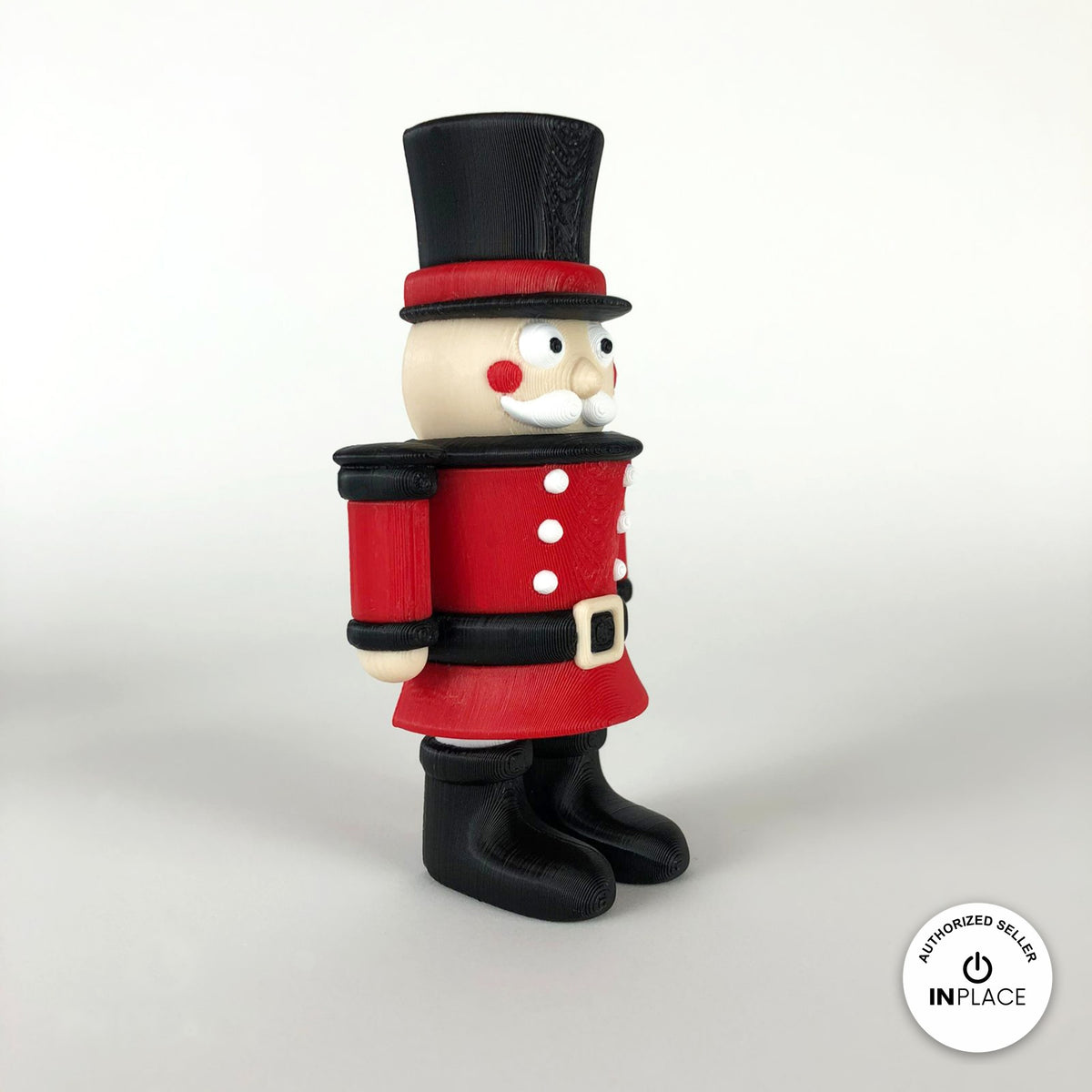 Cute nutcracker soldier keychain, 3D printed by RU3D – side view facing right. Red jacket with black top hat and boots.