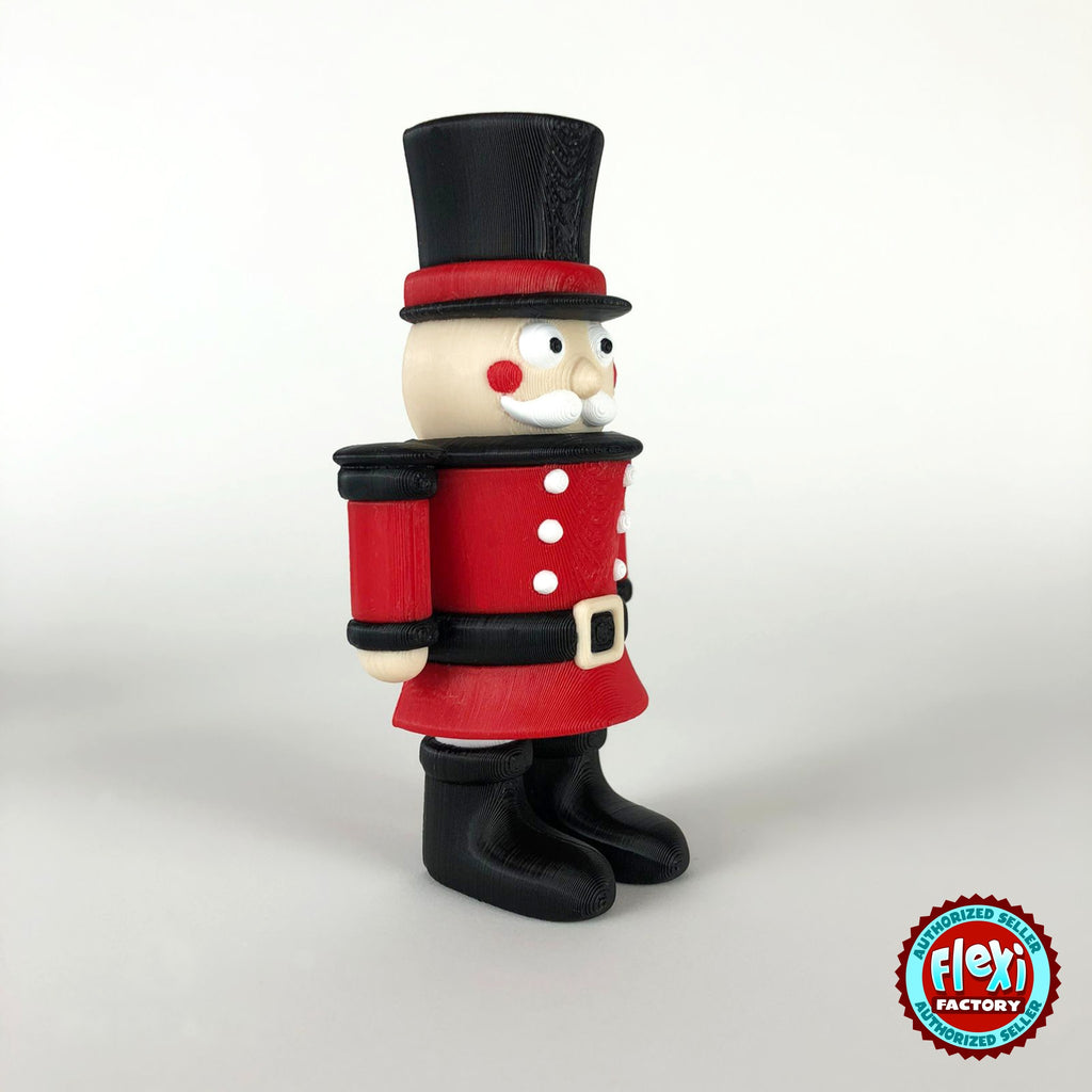 Cute nutcracker soldier keychain, 3D printed by RU3D – side view facing right. Red jacket with black top hat and boots.