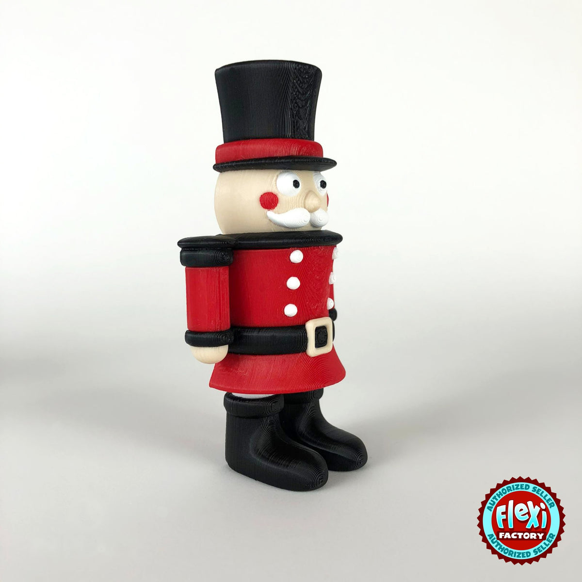 Cute nutcracker soldier keychain, 3D printed by RU3D – side view facing right. Red jacket with black top hat and boots.