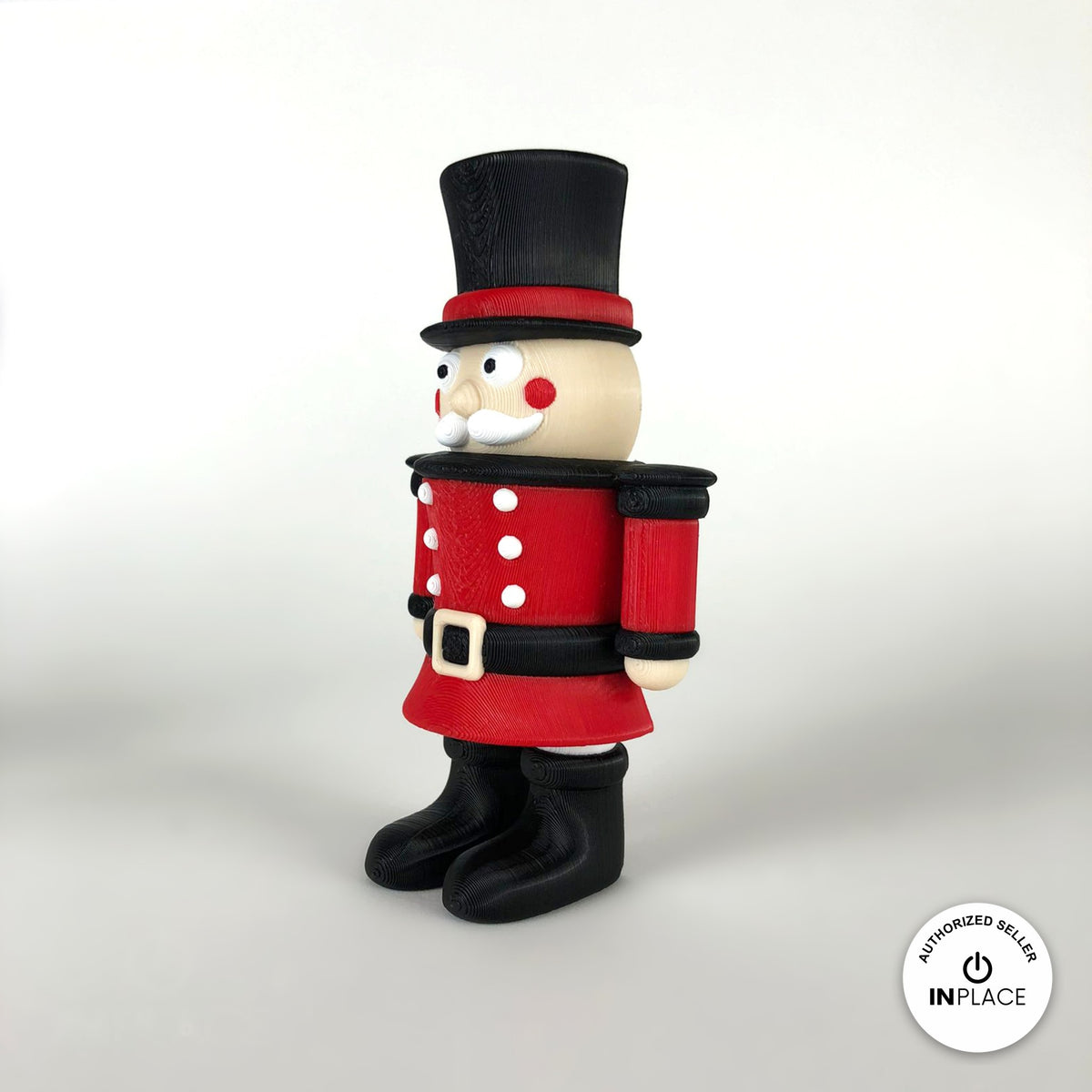 Cute nutcracker soldier keychain, 3D printed by RU3D – three quarter view facing right. Red jacket with black top hat and boots.