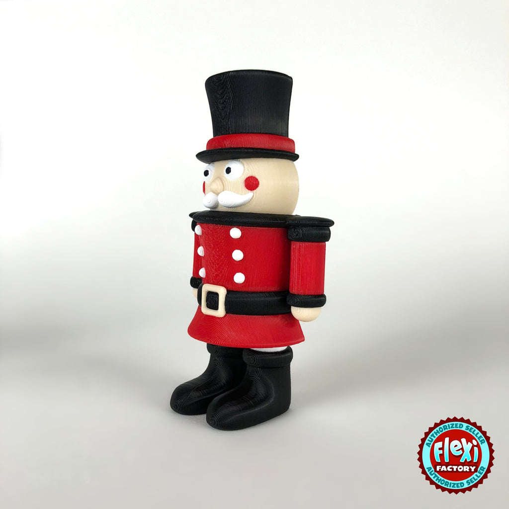 Cute nutcracker soldier keychain, 3D printed by RU3D – three quarter view facing right. Red jacket with black top hat and boots.